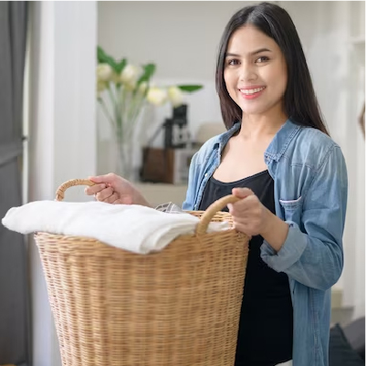 A person holding a basket full of clothes