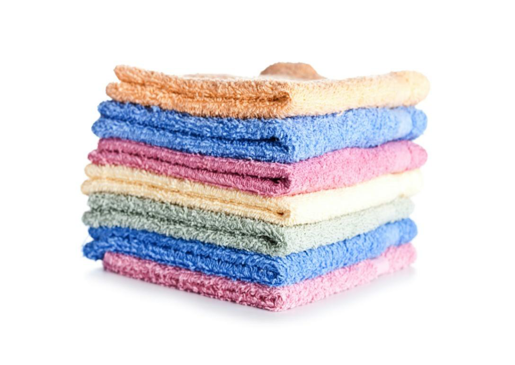 Stack of multicolored towels on a white background