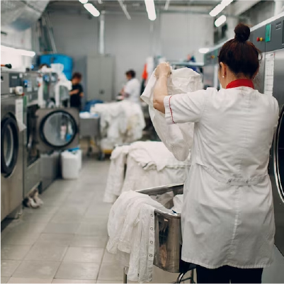 A worker in a laundry facility