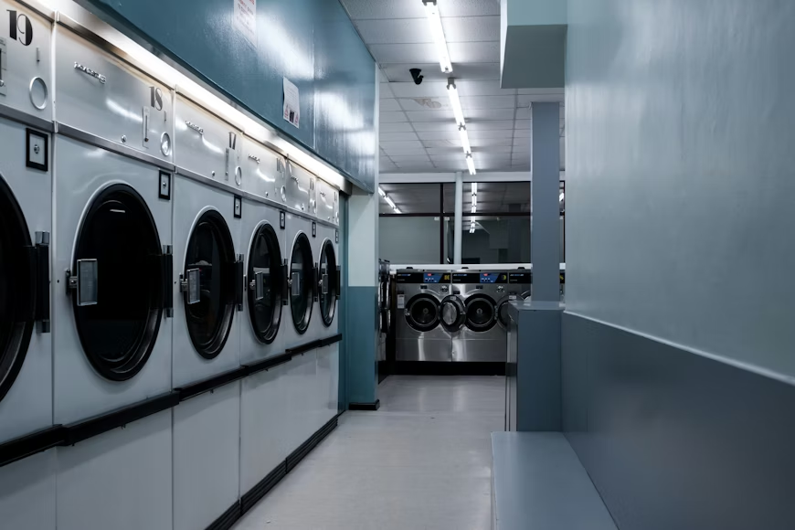 This photo shows a bunch of washing machines.